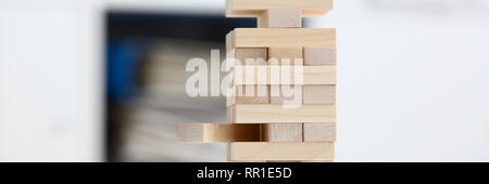 Businessman plays in a strategy of jenga hand Stock Photo