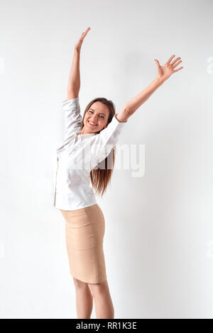 Freedom. Woman standing isolated on white hands up smiling happy side view Stock Photo
