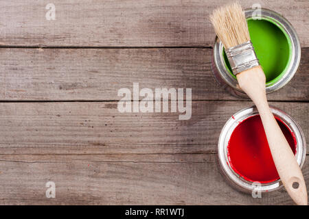 green and red paint in the bank with brush on the old wooden background with copy space for your text. Top view Stock Photo
