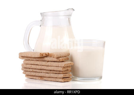 jug and glass of milk with grain crispbreads isolated on white background Stock Photo