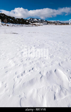 Close up of wind sculpted patterns in fresh snow; Rocky Mountains beyond; Central Colorado; USA Stock Photo