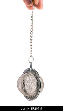 tea strainer on a chain in  hand isolated  white background Stock Photo