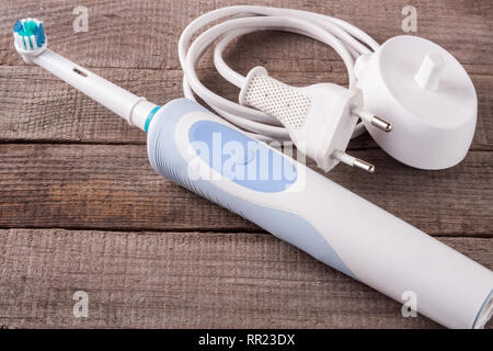 Electric Toothbrush on an old wooden background Stock Photo
