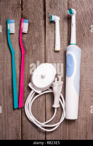 electric and manual toothbrushes on the wooden background Stock Photo