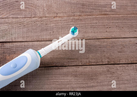 Electric Toothbrush on an old wooden background Stock Photo