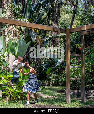 latin siblings playing on playground in Guatemala Stock Photo