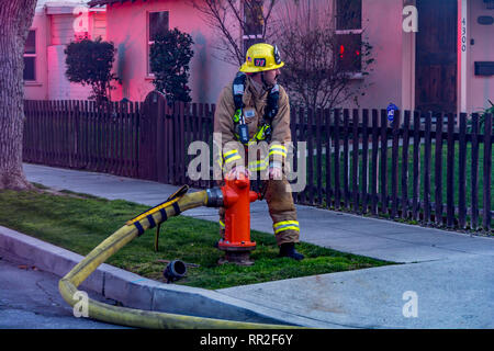 Burbank CA USA 23 February 2019 Burbank Firefighter turning on water from a hydrant at a house fire. Credit: Chester Brown/Alamy Live News Stock Photo