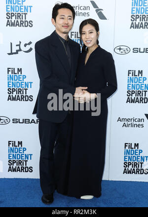 SANTA MONICA, LOS ANGELES, CA, USA - FEBRUARY 23: Actor Steven Yeun and pregnant wife Joana Pak arrive at the 2019 Film Independent Spirit Awards held at the Santa Monica Beach on February 23, 2019 in Santa Monica, Los Angeles, California, United States. (Photo by Xavier Collin/Image Press Agency) Stock Photo