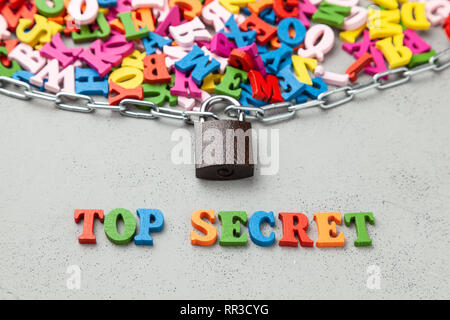 Top Secret Information. Letters of information symbol wrapped in chain and locked Stock Photo