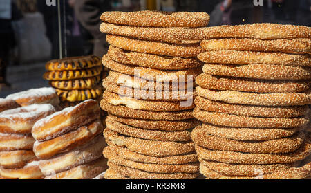 Greek koulouri stack. Traditional street food, crispy sesame bread ring bagels, closeup view