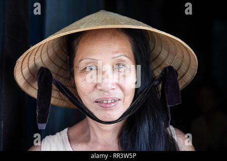 closeup face portrait of vietnam woman wearing conical hat Stock Photo