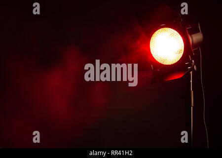 Red light with smoke in the dark. Equipment for photo Studio. Stock Photo