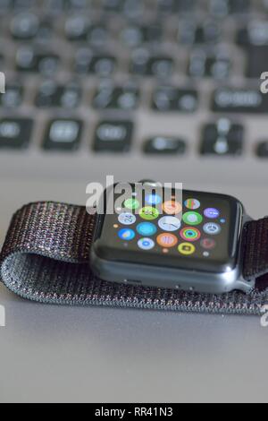 Apple Watch with blurred laptop PC keyboard background. Apple Watch is industry leader smart watch brand Stock Photo