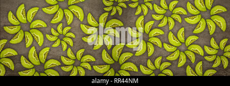 Creative flowers made of Kiwis cut from below lit on a stone background Food concept Stock Photo