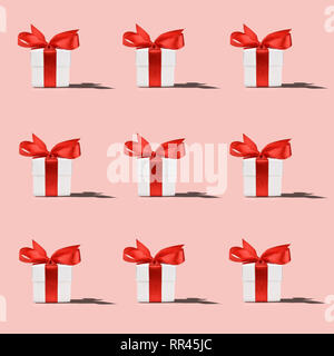 Pattern of white gift box with red ribbon on pink background Stock Photo