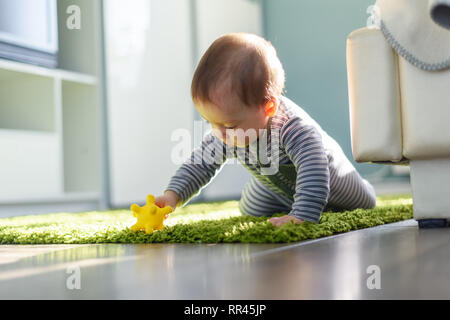 Playing boy on green carpet closeup. Childhood concept Stock Photo