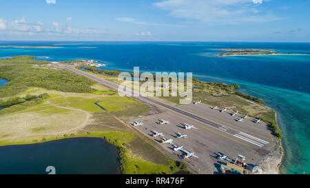 Small airplanes parked in Los Roques islands Airport.. Aerial View Drone Stock Photo