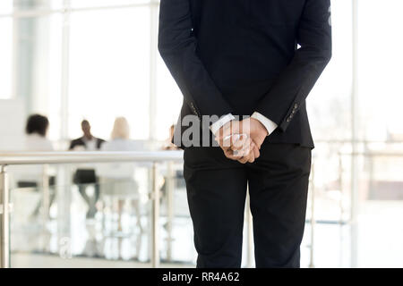 Rear view businessman standing in modern office Stock Photo