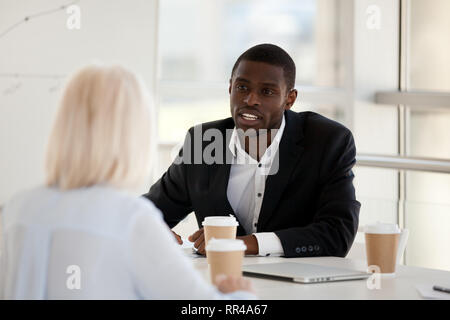 Business people discussing analysing market during briefing Stock Photo