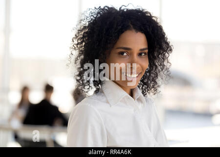 Head shot mixed race successful businesswoman posing looking at camera Stock Photo