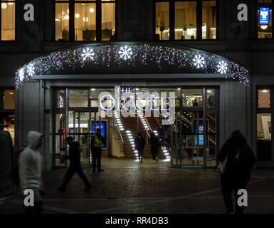 Reading, United Kingdom - January 04 2019:   Nighttime Christmas shoppers enter the Oracle Shopping Centre on Broad Street Stock Photo