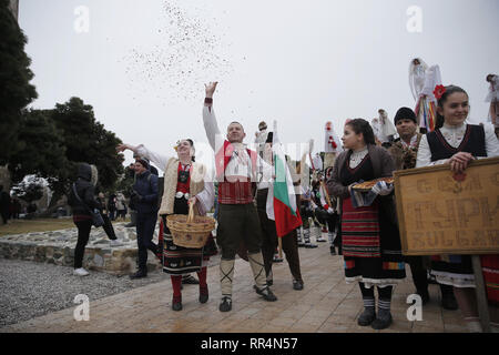 Thessaloniki, Greece. 24th Feb, 2019. Participants from Bulgaria dressed in traditional costumes dance at the seafront of Thessaloniki. The Folklife and Ethnological Museum of Macedonia organized the fifth European assembly of bell bearers in Thessaloniki. The assembly took place in the context of the action ''Bell Roads'', which attempts to explore the customs of bell bearing in Europe. Credit: ZUMA Press, Inc./Alamy Live News Stock Photo