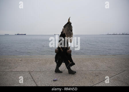 Thessaloniki, Greece. 24th Feb, 2019. A participant wearing a traditional costume walks at the seafront of Thessaloniki. The Folklife and Ethnological Museum of Macedonia organized the fifth European assembly of bell bearers in Thessaloniki. The assembly took place in the context of the action ''Bell Roads'', which attempts to explore the customs of bell bearing in Europe. Credit: ZUMA Press, Inc./Alamy Live News Stock Photo