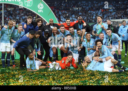 London, UK. 24th Feb, 2019. The Manchester City players with the trophy at the end of the Carabao Cup Final match between Chelsea and Manchester City at Stamford Bridge on February 24th 2019 in London, England. (Photo by Paul Chesterton/phcimages.com) Credit: PHC Images/Alamy Live News Stock Photo