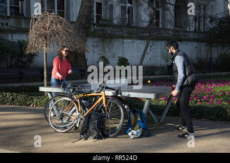 London, UK. 24th February, 2019. A couple enjoy a game of table tennis in Whitehall Gardens, Westminster, London, UK in the early afternoon on this sunny, February spring like day. Credit: Joe Kuis /Alamy Live News Stock Photo