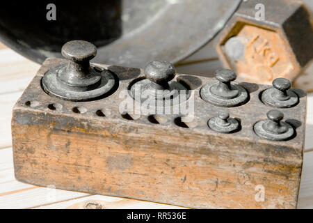 Old rusty scale weight on wooden table, Old rusty iron scale weight Stock Photo