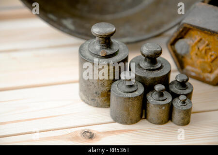 Old rusty scale weight on wooden table, Old rusty iron scale weight Stock Photo