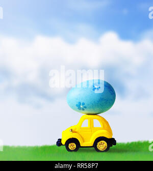 Retro toy car with Easter egg on the roof. on spring background Easter concept. Happy Easter. Stock Photo