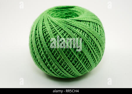 a skein of green wool on a white background Stock Photo