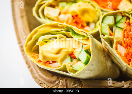 Vegan tofu wraps with cashew cheese sauce and vegetables, white background. Stock Photo