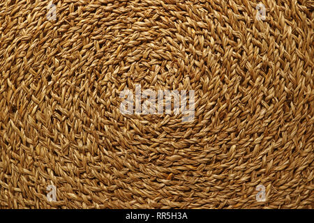 Artistic pattern of golden brown woven sedge place mat surface Stock Photo