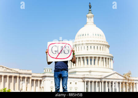 Protester holding sign against gun violence in hands Stock Photo
