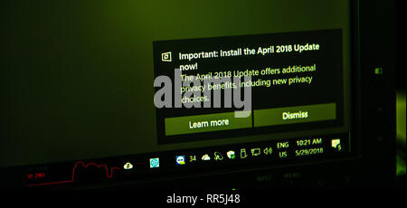 Paris, France - May 29, 2018: Message on the corner of a Computer display Important message install the current April 2018 Update now with new privacy benefits and improvements  Stock Photo
