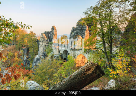 Bastei bridge in the evening sun in the national park Saxon Switzerland. Elbe sandstone mountains with trees in autumn colors and rock formations and Stock Photo