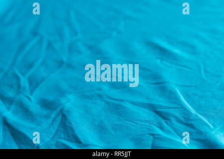 blue color creased textile selective focus background Stock Photo