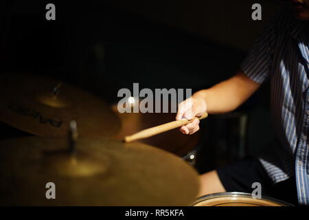 Student learn to play drum | Hand holding stick thumping the drum in the classroom Stock Photo