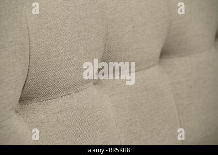 Grey fabric sofa, close up detail with buttons Stock Photo