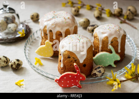 Easter composition of Easter cakes, biscuits, eggs and forsythia flowers. Rustic style, selective focus. Stock Photo