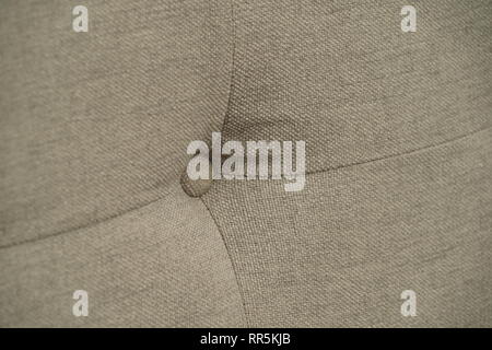 Grey fabric sofa, close up detail with buttons Stock Photo