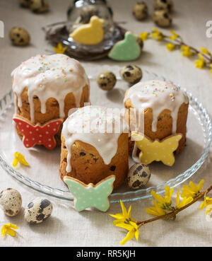 Easter composition of Easter cakes, biscuits, eggs and forsythia flowers. Rustic style, selective focus. Stock Photo