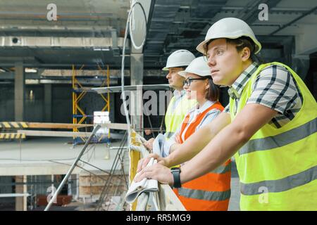 Team of builders, engineers, architects at construction site, copy space. Construction, development, teamwork and people concept Stock Photo