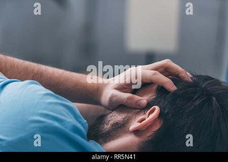 selective focus of grieving man covering face with hands and crying at home Stock Photo