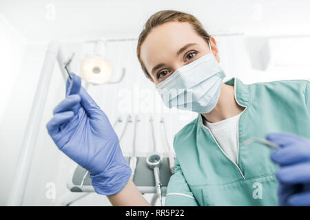 female dentist in mask and latex gloves near patient Stock Photo - Alamy