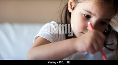 Attentive 5 years old child girl painting with felt-tip pen. Attention deficit hyperactivity disorder concept Stock Photo