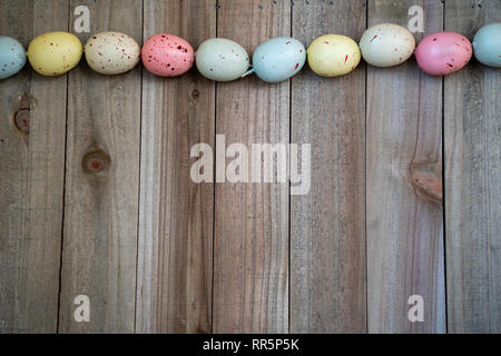 Flat lay speckled easter egg spring concept on a wood background Stock Photo