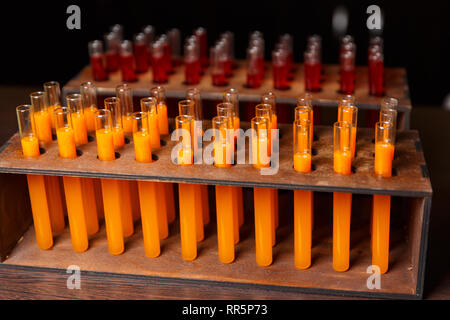 Photo of test tubes with orange liquid in laboratory Stock Photo